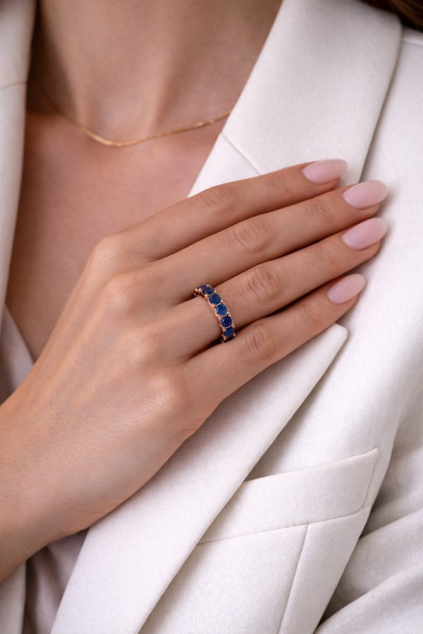 Žiedas juostelė su safyrais raudonas auksas ant stilingos merginos rankos